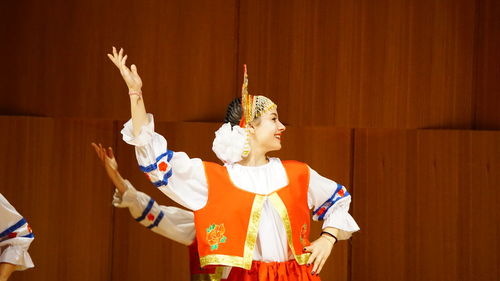 Smiling woman performing traditional dance