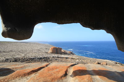 Rock formations by sea against sky