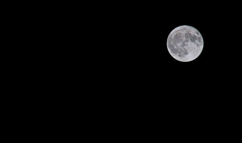 Low angle view of moon against clear sky at night