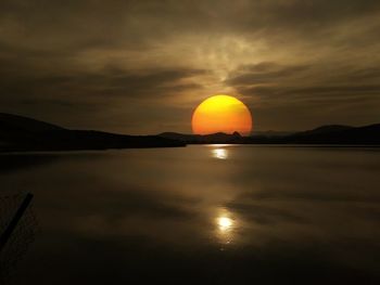 Scenic view of sunset over mountain against sky