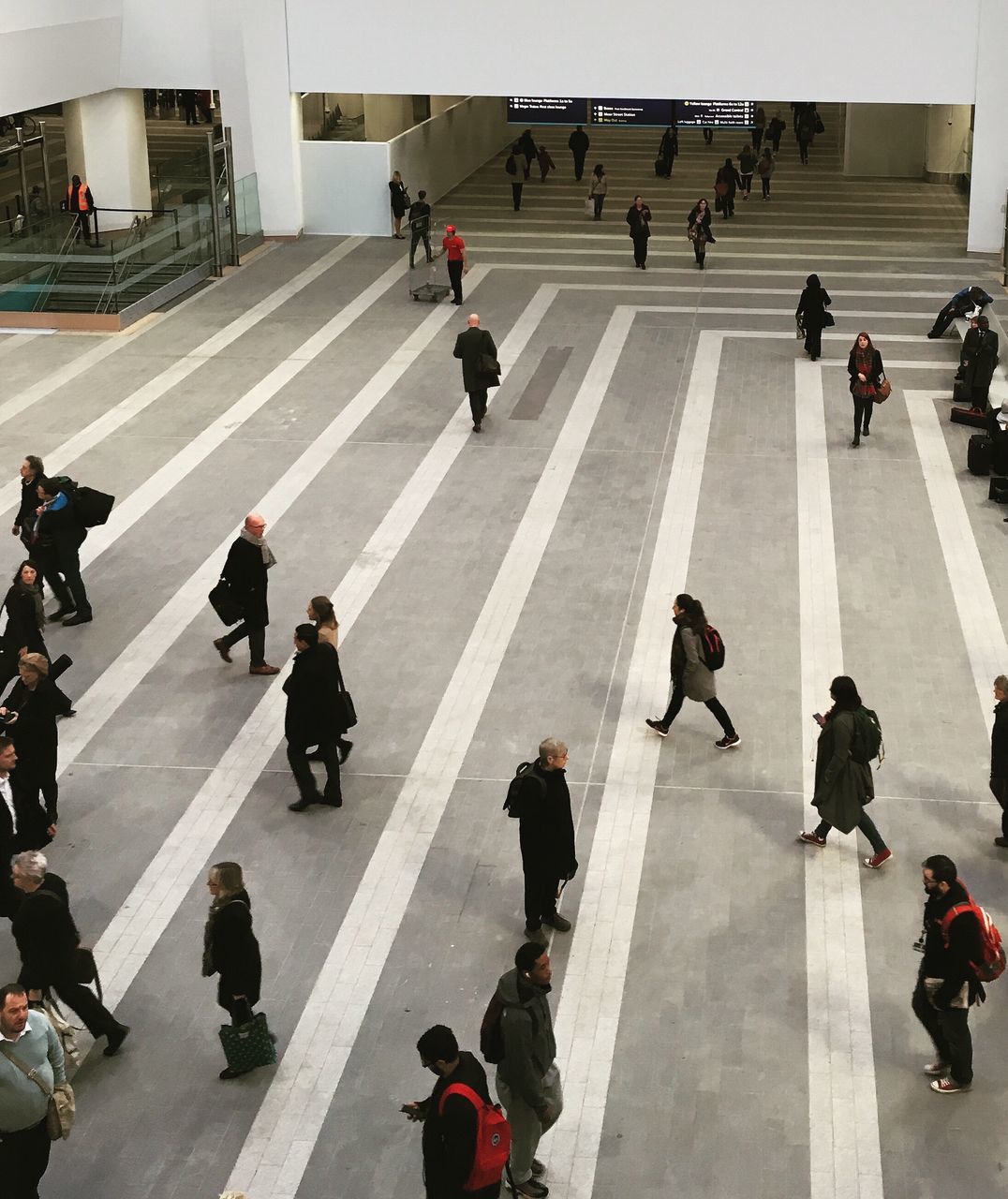 large group of people, person, men, lifestyles, walking, architecture, built structure, city life, mixed age range, city, leisure activity, high angle view, street, transportation, road marking, building exterior, crowd, day, medium group of people