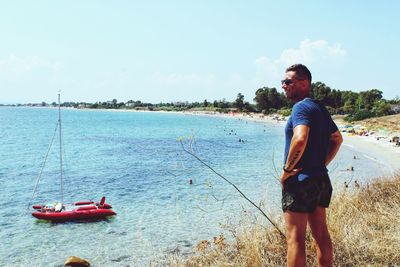 Man standing on beach against sky