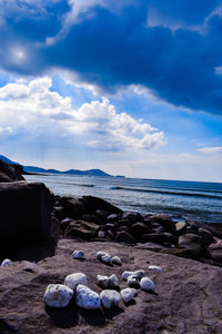 Rocks on beach against sky