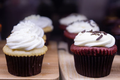 Close-up of 2 line of cupcakes on table