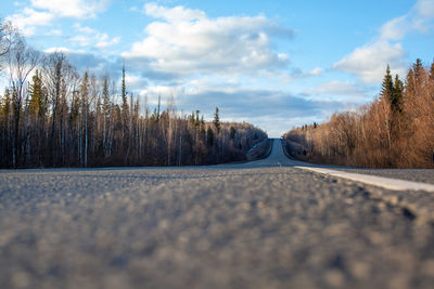 Surface level of empty road against sky