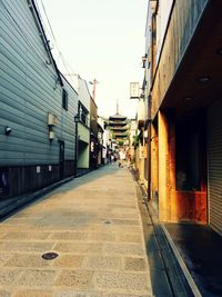 Empty road leading towards building