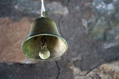 Close-up of bell hanging against wall