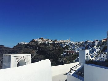 Town against clear blue sky