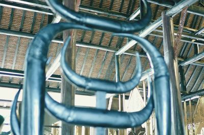 Close-up of metal chain against fence