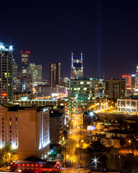 Illuminated cityscape against clear sky at night