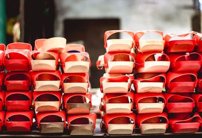 Close-up of stacked sandals arranged on table