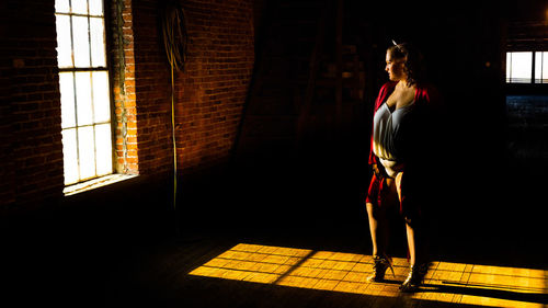 Rear view of woman walking on wall