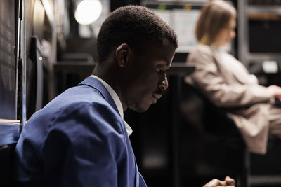 Side view of man working at office