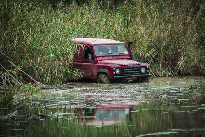 Boat on grass by water