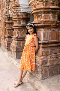 A pretty indian girl child near a terracotta temple of west bengal