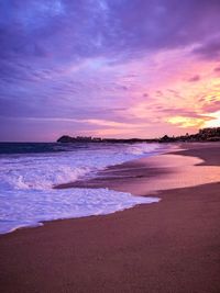 Scenic view of beach against sky during sunset