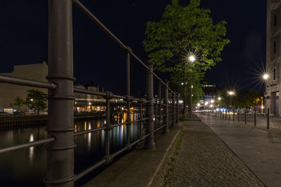 View of illuminated street lights at night