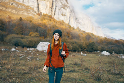 Portrait of smiling young woman standing outdoors