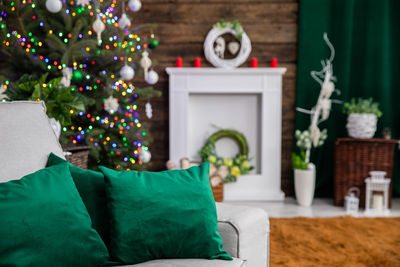 Low section of woman with christmas tree at home