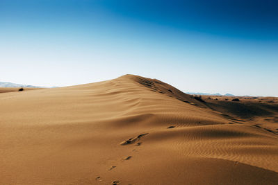 Scenic view of desert against clear sky