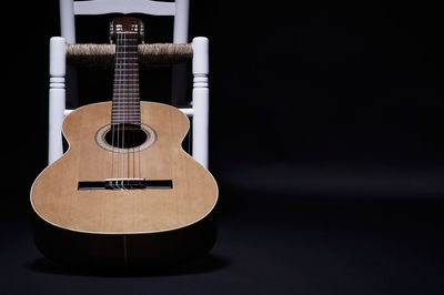 Close-up of guitar against black background