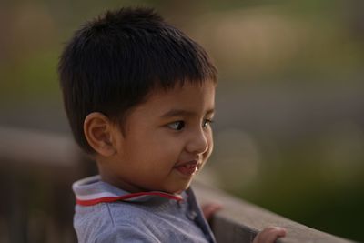 Close-up of cute boy looking away