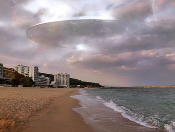 View of beach against cloudy sky