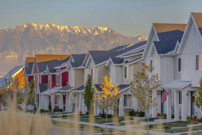 Houses and buildings in city against sky