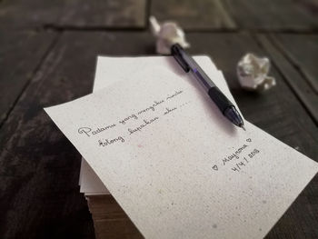 Close-up of text on paper at table