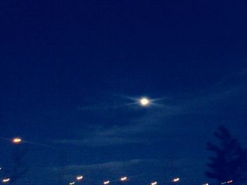 Low angle view of moon against blue sky