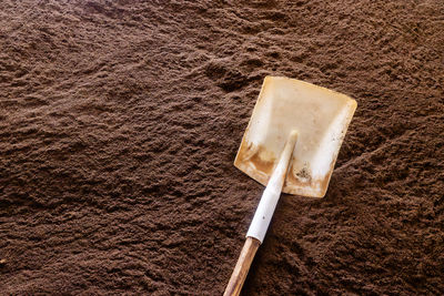 Shovel on pile of tea during producing process in tea factory in sri lanka.