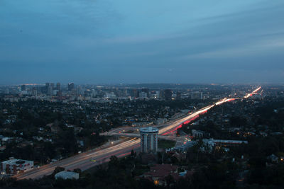 Illuminated cityscape against sky at night