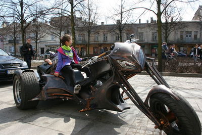 Man riding motorcycle on street in city