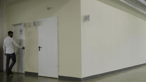 Rear view of man standing in building