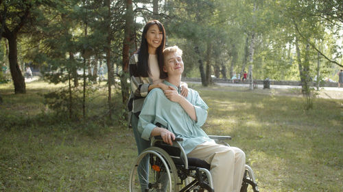 Portrait of young woman sitting on field