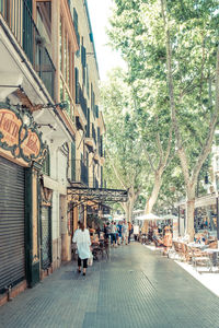 People walking on street in city