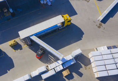 Warehouse man worker with forklift. loading trucks. aerial view
