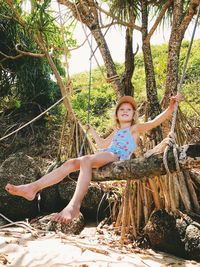 Portrait of girl on tree trunk
