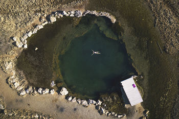 Aerial view of woman swimming in lake