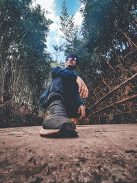 Low angle view of young man in forest