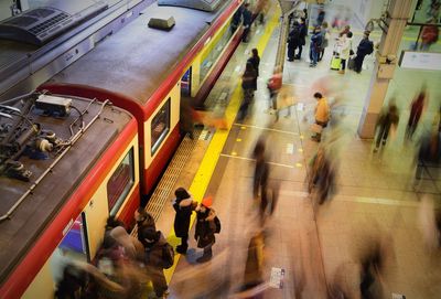 Blurred motion of people on railroad station