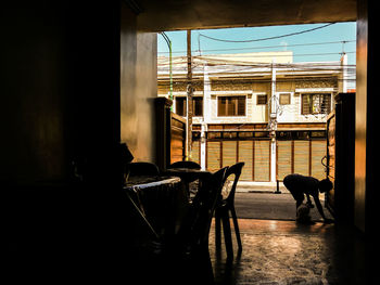 Silhouette woman with dog on doorway