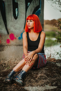 Portrait of young woman sitting outdoors