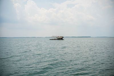 Boat sailing in sea against sky