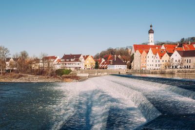 Buildings against clear blue sky