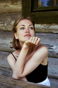 Portrait of a young woman sitting outdoors