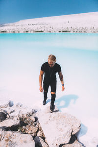 Full length of man on rock at beach