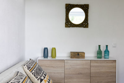 Table and chairs on white wall at home