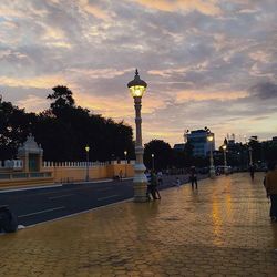 View of city street against cloudy sky