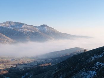 Scenic view of snowcapped mountains against clear sky